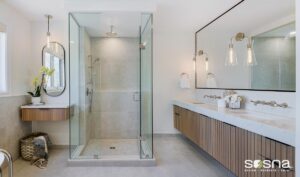 Modern bathroom with custom floating vanity, quartz countertop, and frameless glass shower featuring elegant stone finishes and minimalist design.