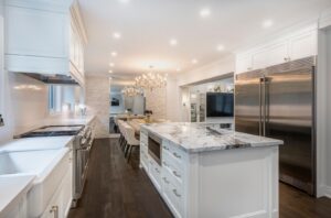 Luxury kitchen with custom marble-style quartz countertops, waterfall island, and premium stone surfaces designed for modern homes in the GTA.