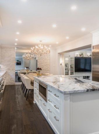 Luxury kitchen with custom marble-style quartz countertops, waterfall island, and premium stone surfaces designed for modern homes in the GTA.