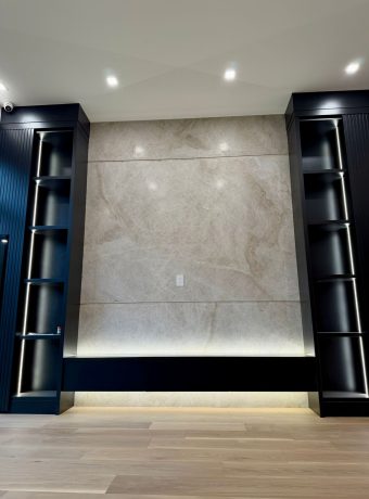 Modern custom porcelain feature wall with built-in shelving, designed and installed by ECCO Stone Works in Toronto GTA.